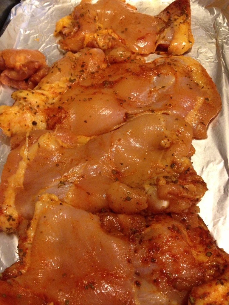 Chicken thighs rubbed with paprika, oregano, cumin and olive oil.  Marinated and ready for the oven.