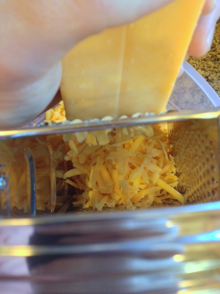 Do yourself a favor and start grating your own cheese.  Packaged shredded cheese usually contains an extra ingredient to keep it from sticking together, which also affects the way the cheese melts.  Buy a block and shred it yourself.  It's creamier, richer and just plain better.