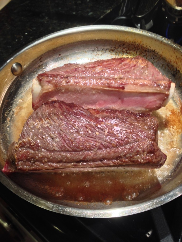 Seasoned and in the smoking hot pan, getting browned and crusty on all sides!