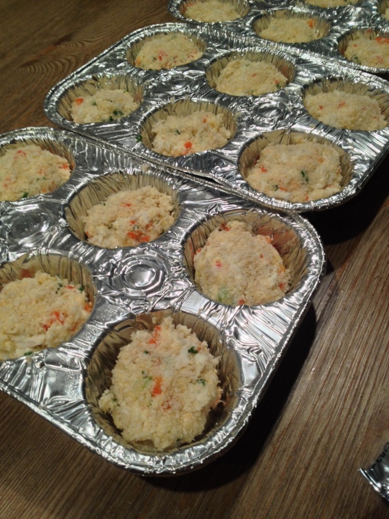 I breaded and formed the crab cakes and put them into buttered muffin tins.  Then, I topped them with a few pats of butter.  The client warmed the crab cakes in the oven until golden brown and topped with remoulade sauce.  Easy peasy.
