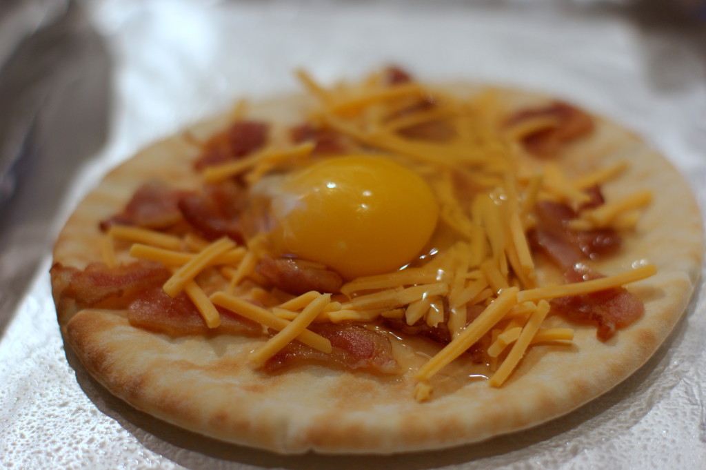 Crack each egg into a bowl before adding to the pita to make sure your pizzas are eggshell free!